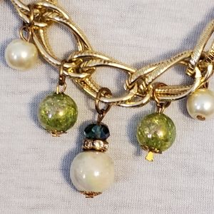 Goldtone necklace with iridescent faux pearl and green bead charms